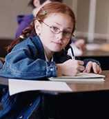 A girl taking notes in class